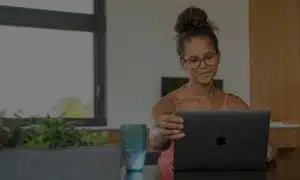 Girl in glasses looking up something on her computer